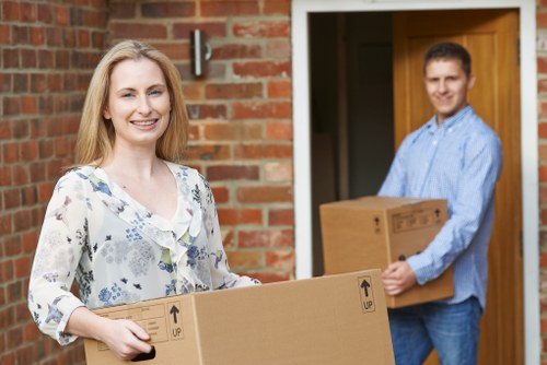 Piano moving team navigating stairs during a Wembley relocation