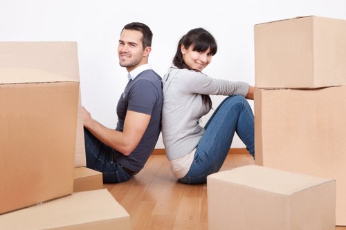Careful wrapping of fragile household items during a Wembley packing service