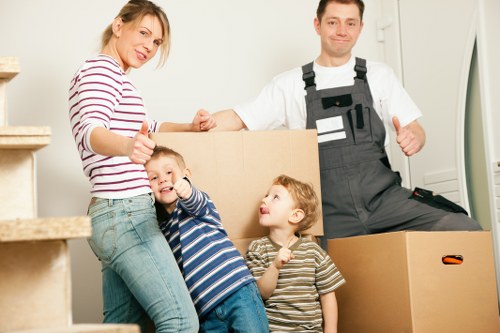 Packing boxes and furniture into a moving truck in Wembley